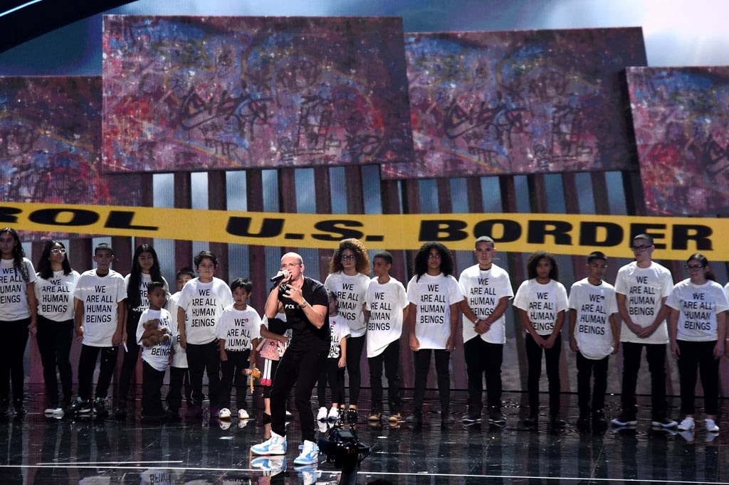 Logic joins immigrant parents and children onstage at the 2018 MTV VMAs